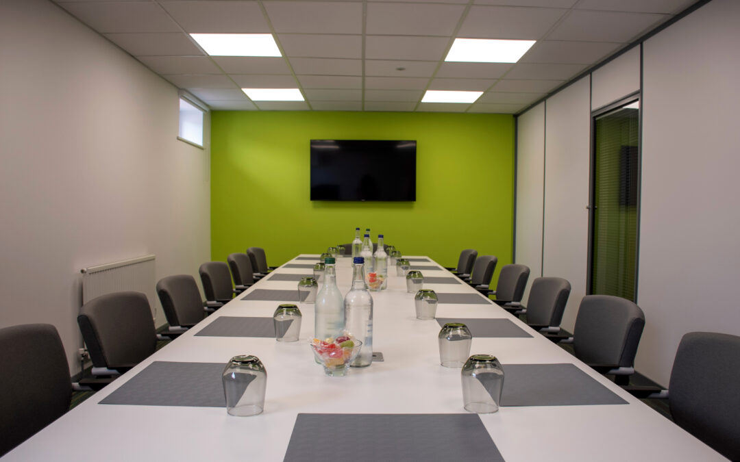 Meeting Room in Newton Abbot. Boardroom style with tv screen and green wall.