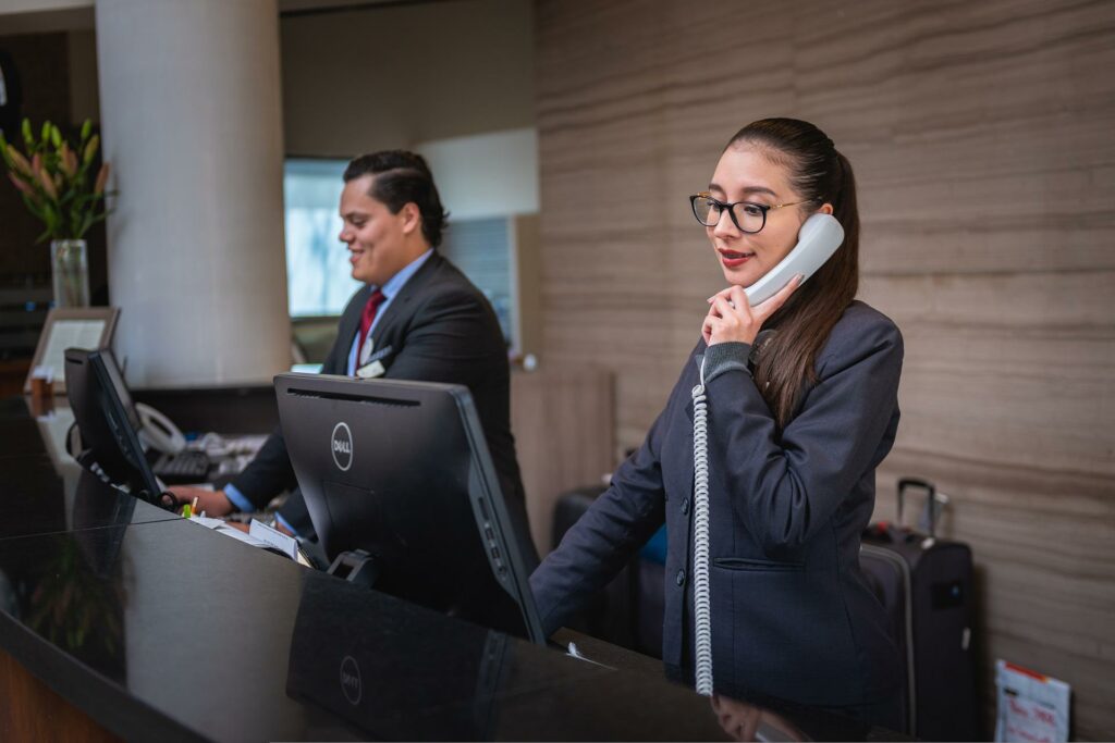 2 receptionist - 1 one the phone, one working on the computer 