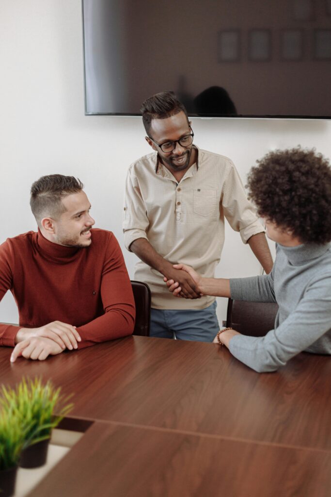 3 people shaking hands and meeting up. 