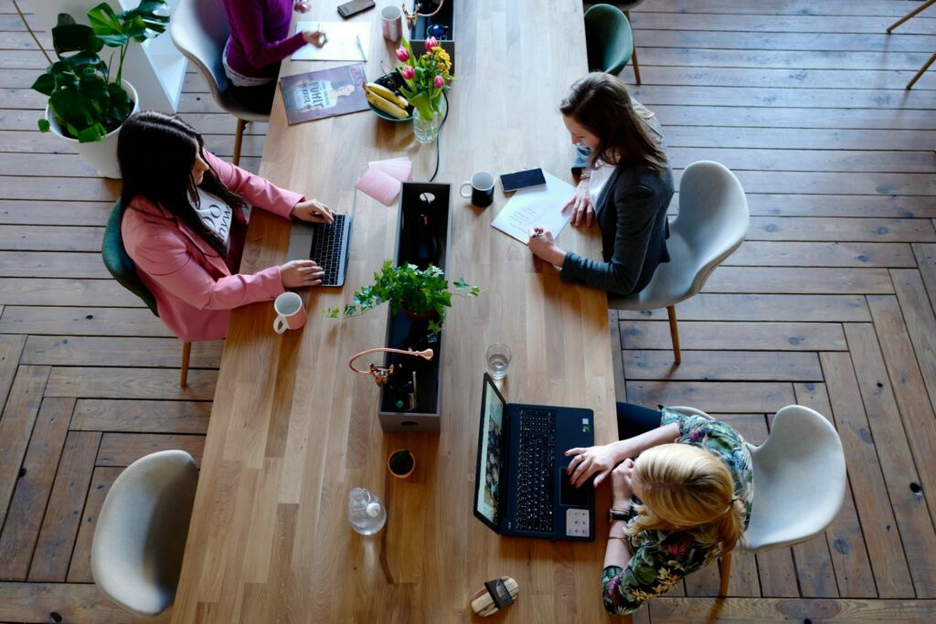 Group of people sat around a table working separately