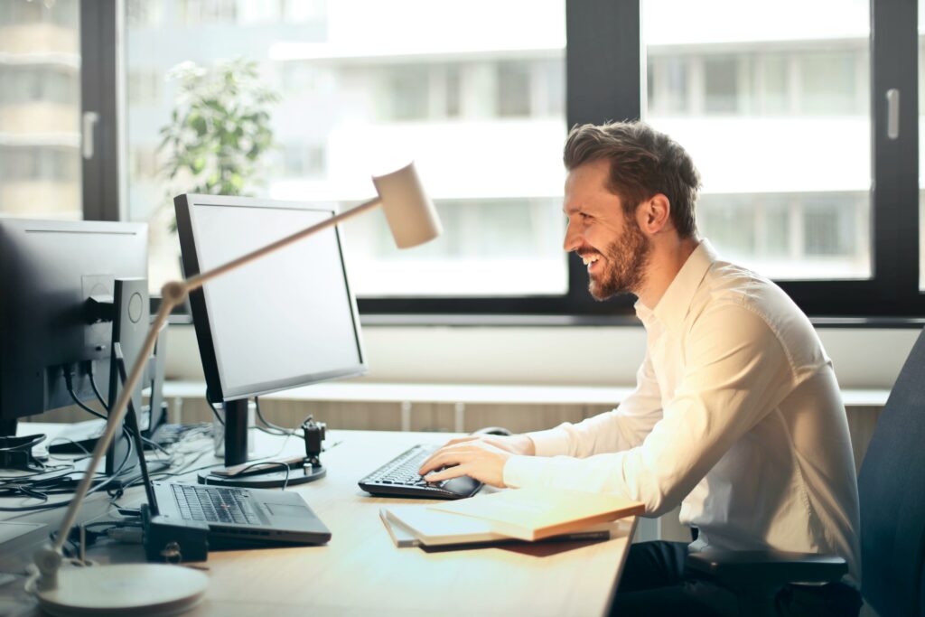 Man looking at a screen with a lamp over him